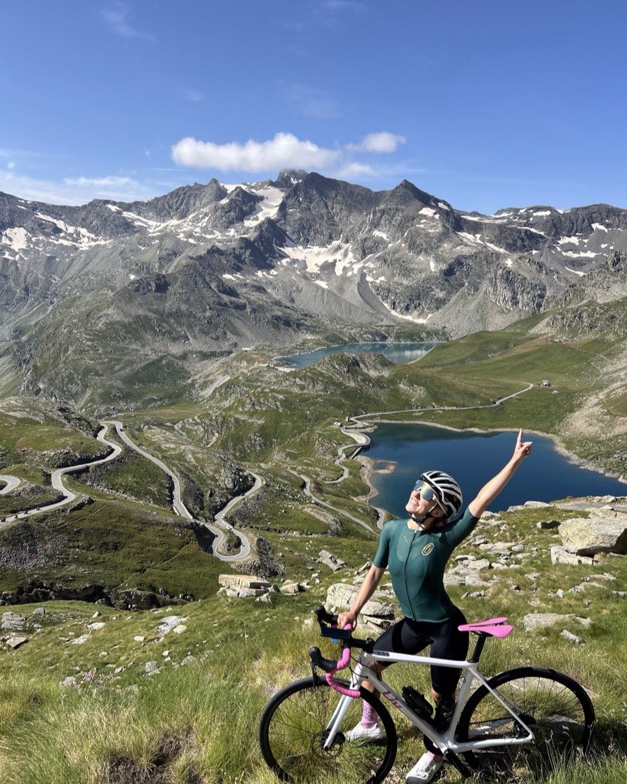 Elaine on her road bike at the top of a mountain pass